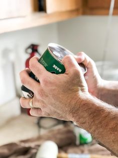 a man holding a can of beer in his hand