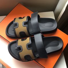 Hermes H Logo Black And Khaki Leather Chypre Sandals Flats Brand New With Box Size 41.5. With The Box And 2 Dust Bags. 100 % Authentic. Have The Proof Of Purchase From Poshmark. Luxury Leather Sandals With Leather Trim, Luxury Sandals With Leather Trim For Summer, Luxury Leather Trim Sandals For Summer, Designer Sandals With Leather Trim For Summer, Designer Open Toe Sandals With Leather Trim, Luxury Black Calf Leather Slides, Luxury Black Sandals With Rubber Sole, Luxury Black Sandals With Leather Lining, Luxury Black Slides With Leather Sole