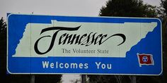 a blue and white sign that says tennessee the volunteer state welcomes you to tennessee