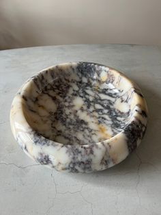 a marble bowl sitting on top of a table