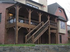 a large brick building with stairs leading up to the upper level and second story windows