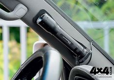 the inside of a car with an electronic device in it's dash board and steering wheel