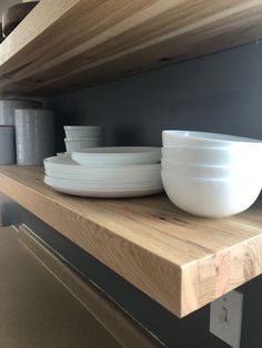 bowls and plates are sitting on the shelf