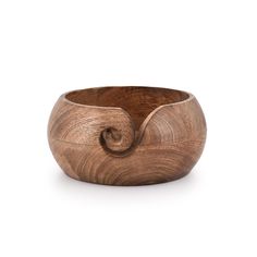 a wooden bowl with an intricate design on the top and bottom, made out of wood