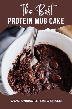 the best protein mug cake recipe with chocolate frosting in a white bowl on a wooden table