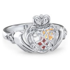 A symbol of loyalty, friendship, and love, this Claddagh design features a Celtic-inspired caged heart. The three-dimensional cage holds 2 or 3 loose heart-shaped birthstones sealed inside to represent your loved ones. Design yours in sterling silver, white, yellow, or rose gold with a choice of gemstones and personalize with a unique ring base engraving for the perfect gift for someone special. Blonde And Blue Hair, Celtic Claddagh Ring, Ring With Gemstone, Knot Rings, Air Force One Shoes, Silver Claddagh Ring, Purple Wedding Dress, Mothers Ring, Family Jewelry