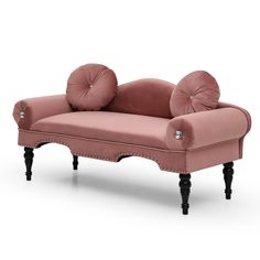 a pink couch with two pillows on it