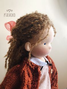 a close up of a doll with long hair