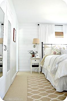 a bedroom with a bed, dresser and mirror in it's centerpieces