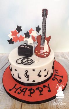 a birthday cake decorated with musical instruments and stars