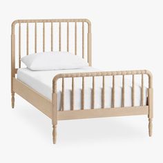 the bed frame is made from wood and has white sheets