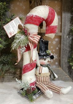 a christmas decoration with a snowman and candy cane