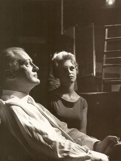 a man sitting next to a woman in a chair