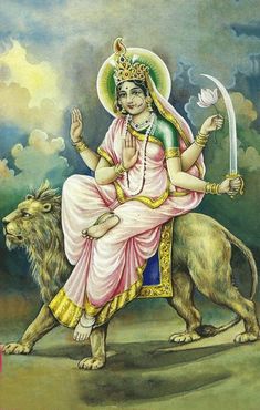 the hindu goddess sitting on top of a lion