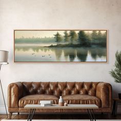 a living room with a leather couch and coffee table in front of a painting on the wall