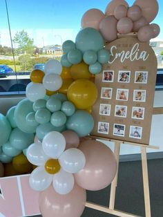 balloons are arranged in the shape of flowers and photos on a sign that says special