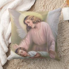 a pillow with an angel holding a child