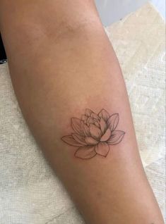 a woman's arm with a tattoo on it and a flower in the middle