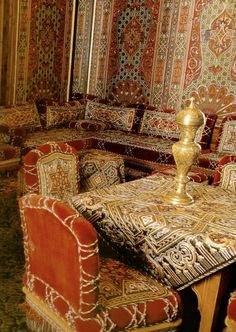 an ornately decorated living room with couches and tables