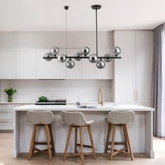 two stools sit in front of a kitchen island