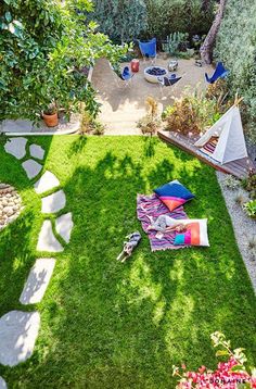 an aerial view of a backyard with lawn, chairs and hammock set up