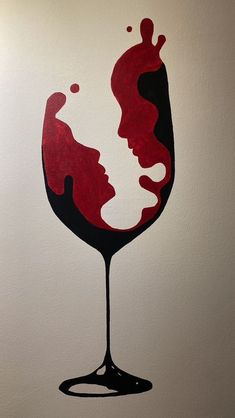 a drawing of a woman's face in a glass of red wine on a white wall