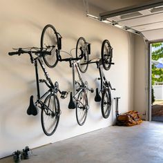 there are three bikes hanging on the wall