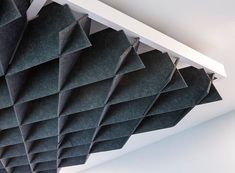 a room that has some kind of black paper on the ceiling and it looks like an origami structure