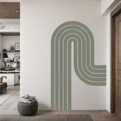 a room with a large wall decal that has an abstract design in the middle