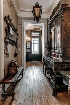 an old fashioned hallway with wooden floors and antique mirrors on the wall, along with two benches