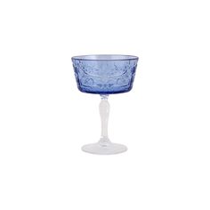 a blue glass sitting on top of a white table