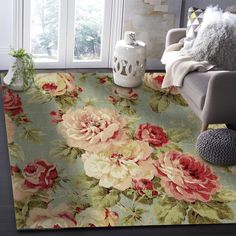 a living room with a floral rug on the floor