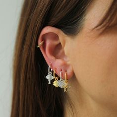 Make your ears the talk of the town with our Earring Charm! Change up your vibe with your charms – mix and match or stack 'em up! Our charms are perfect for pairing with our Tiny Hoops to give you the cutest touch. Get creative and show off your style! Small Hoop Earrings With Charm, Small Hoop Earrings With Dangling Charms, Gold Hoop Earrings With Charms, Charm Hoop Earrings Gold, Charm Small Hoop Metal Earrings, Earring Charm, Hoop Charms, Talk Of The Town, The Talk