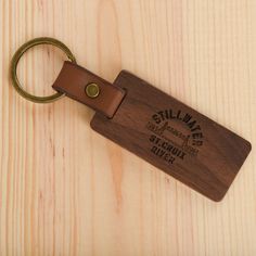 a wooden keychain with a metal ring attached to it