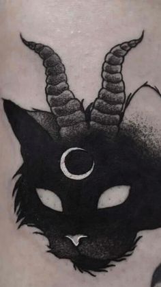 a black cat with horns on its head and crescent moon in the middle of it's nose