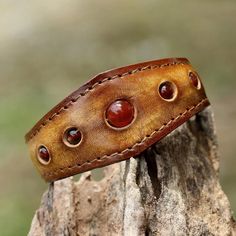 Carnelians Are Displayed Along A Leather Cuff That Has A Stainless Steel Wire Inside So It Can Be Adjusted To Allow For A Wide Range Of Wrist Sizes. Carnelian Is Known As A Stone Of Motivation And Endurance, Leadership And Courage. Carnelian Is An Orange-Colored Variety Of Chalcedony, A Mineral Of The Quartz Family. 0.65 Oz 7" L (End To End) X 1.2" W Leather, Carnelian Natural Carnelian Stone Leather Bracelet With Stone, Diy Leather Projects, Leather Craft Patterns, Handmade Leather Bracelets, Leather Wristbands, Polymer Clay Necklace, Clay Necklace, Leather Cuffs Bracelet, Leather Projects