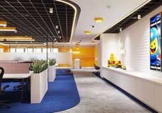 an office with blue carpet and yellow walls