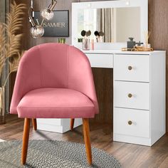 a pink chair sitting in front of a white desk with a mirror on top of it