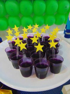 purple cups with yellow stars are on a white plate