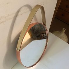 a mirror that is on the side of a wall