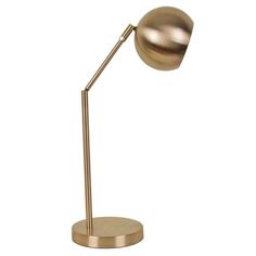 a gold colored desk lamp with a metal base on an isolated white background the light is dimming