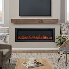 a living room with a couch, coffee table and television mounted on the wall above it