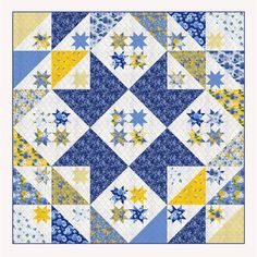 a blue and yellow quilt with many stars on it's sides, in the center