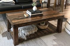 a living room with a couch, coffee table and books