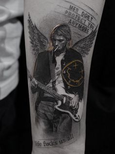 a man with a guitar tattoo on his arm