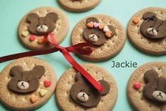 cookies decorated with teddy bears and candy are arranged in the shape of hearts on top of each cookie