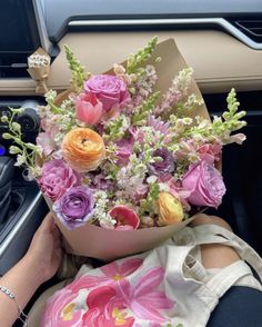 a bouquet of flowers sitting on the dashboard of a car