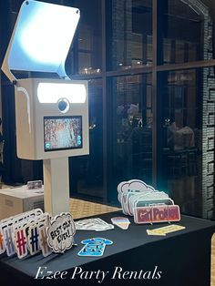 a table topped with lots of cards and a projector light on top of it