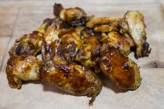 some chicken wings are sitting on a cutting board