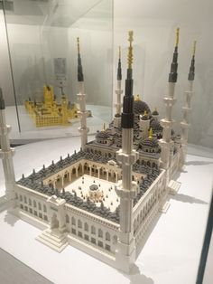 a model of a building made out of legos in a glass case on display